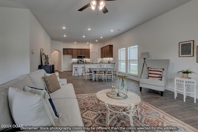 living room featuring ceiling fan and wood-type flooring