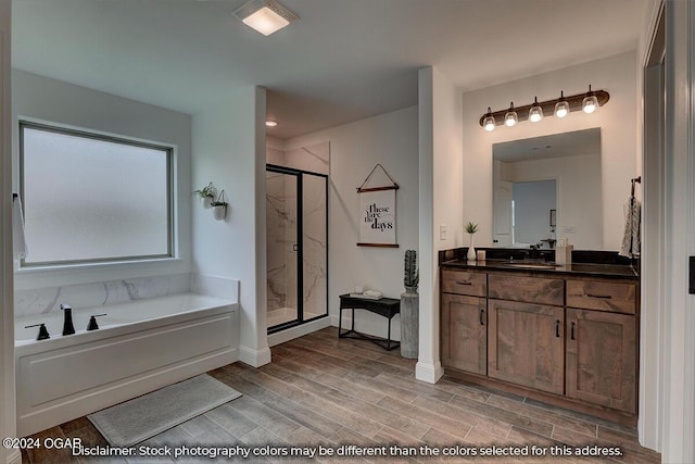 bathroom featuring vanity, shower with separate bathtub, and hardwood / wood-style floors