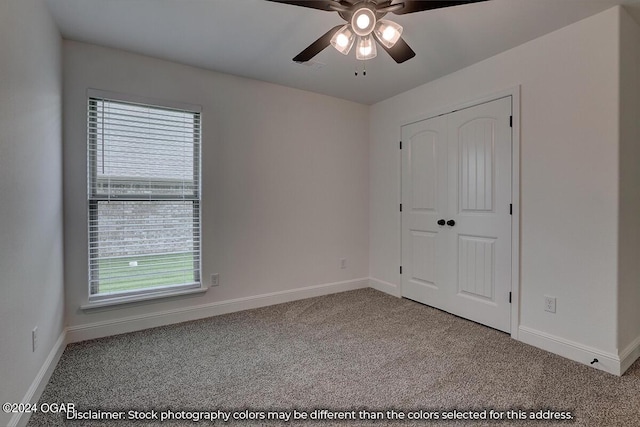 unfurnished room with carpet floors and ceiling fan