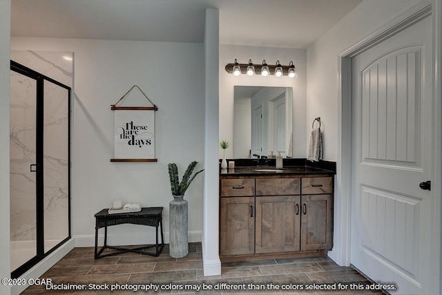 bathroom with vanity and a shower with shower door