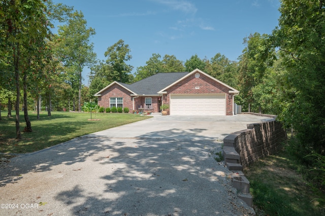 view of front of house with a garage and a front yard