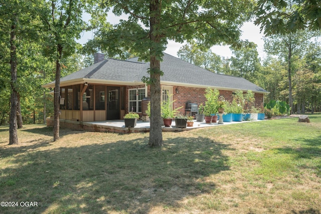 7221 State Highway 90, Pineville, MO 64856 - rear view of house with roof with shingles, a sunroom, a chimney, a patio, and a yard
