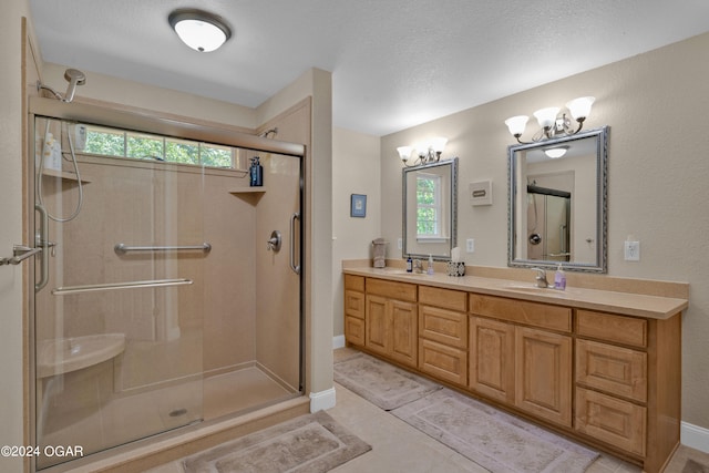 bathroom featuring a wealth of natural light, tile patterned flooring, vanity, and walk in shower