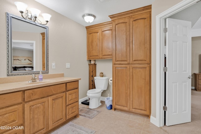 bathroom featuring toilet, tile patterned flooring, and vanity