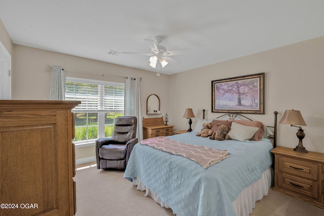 bedroom with ceiling fan and light carpet