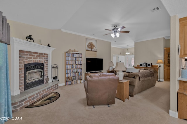 living room featuring ceiling fan, crown molding, light colored carpet, and a fireplace