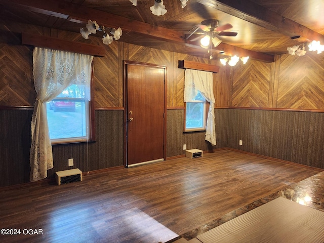 additional living space featuring dark hardwood / wood-style floors, wood ceiling, beam ceiling, and wood walls