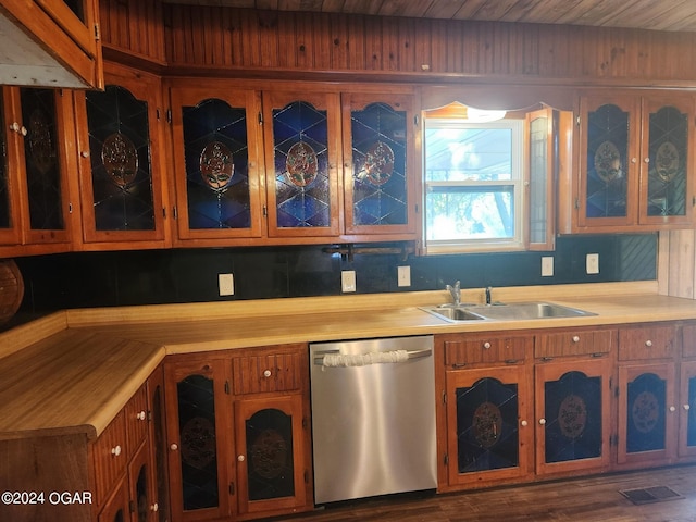 kitchen featuring dishwasher, sink, and dark hardwood / wood-style floors