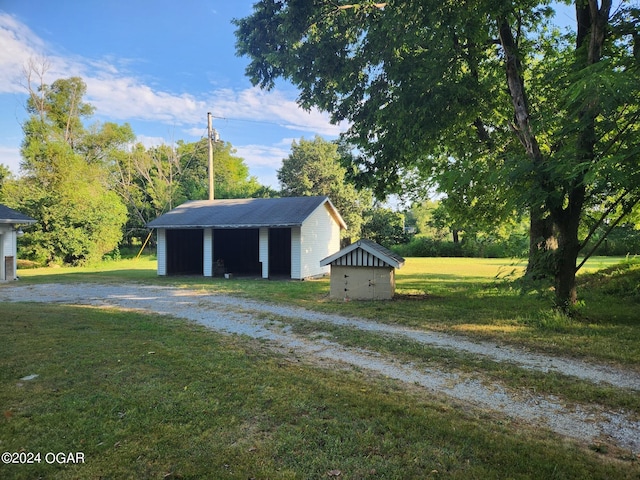 view of outbuilding featuring a lawn