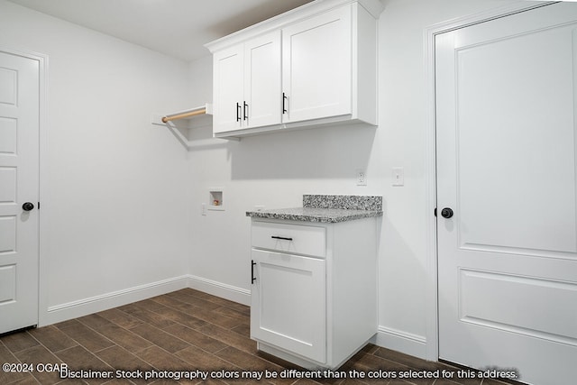 clothes washing area featuring cabinets and hookup for a washing machine