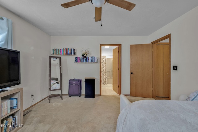 carpeted bedroom featuring connected bathroom and ceiling fan