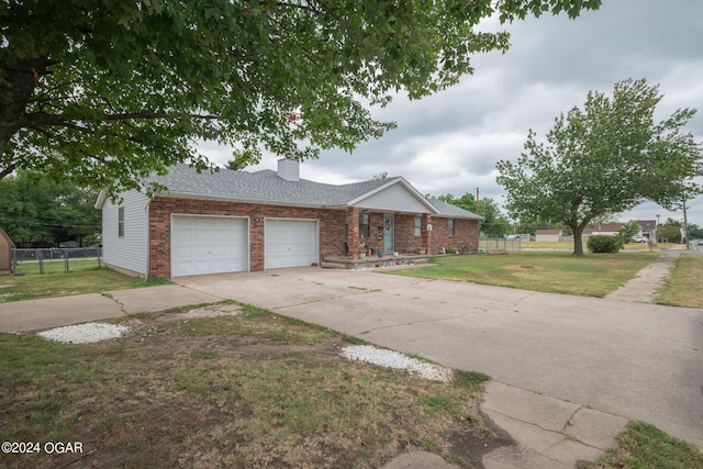 ranch-style house featuring a garage and a front yard