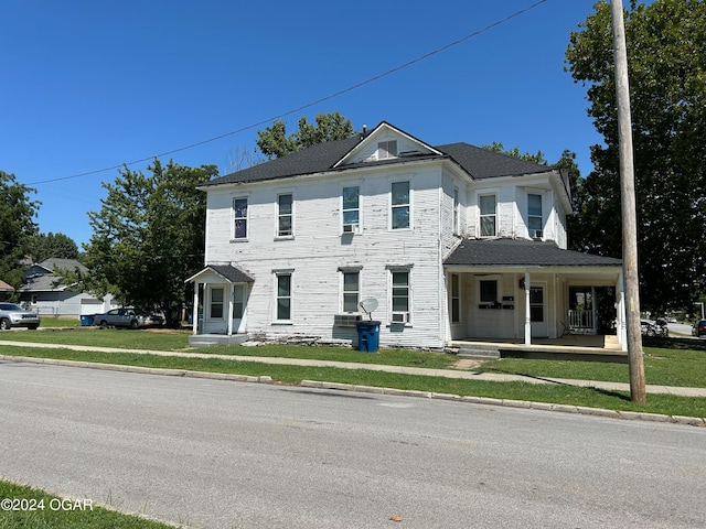 view of front of home with a front yard and covered porch