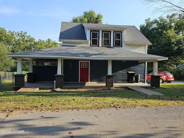 farmhouse inspired home with a chimney, roof with shingles, a porch, and a front yard