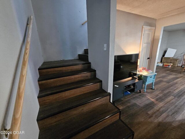 staircase with hardwood / wood-style floors