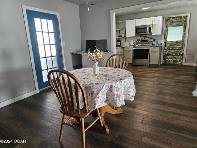 dining space with dark wood-type flooring