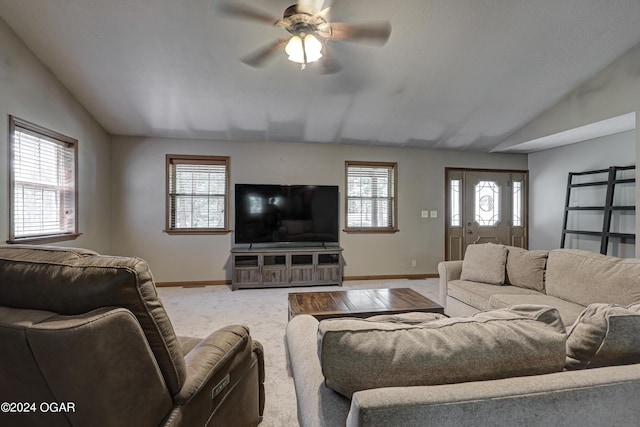 living area featuring vaulted ceiling, carpet floors, ceiling fan, and baseboards