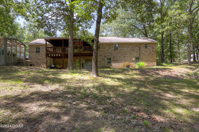 rear view of property with a wooden deck