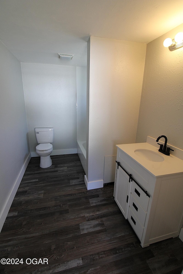 full bathroom featuring bathtub / shower combination, wood-type flooring, toilet, and vanity