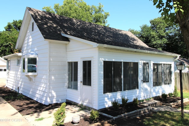 view of property exterior featuring a shingled roof