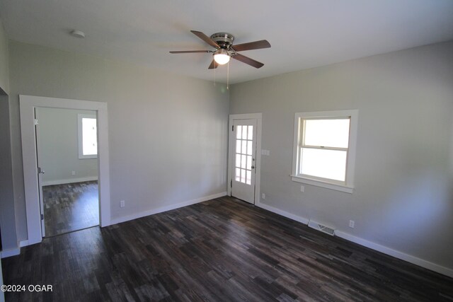 unfurnished room featuring ceiling fan, a healthy amount of sunlight, and wood-type flooring