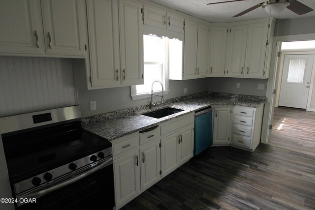 kitchen with ceiling fan, stainless steel appliances, dark wood-type flooring, and white cabinetry