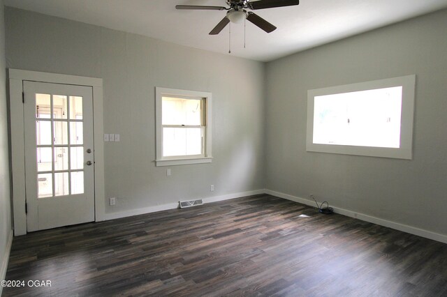 spare room with ceiling fan, dark hardwood / wood-style floors, and a healthy amount of sunlight