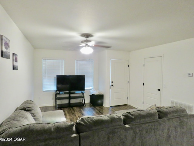 living room featuring hardwood / wood-style floors and ceiling fan