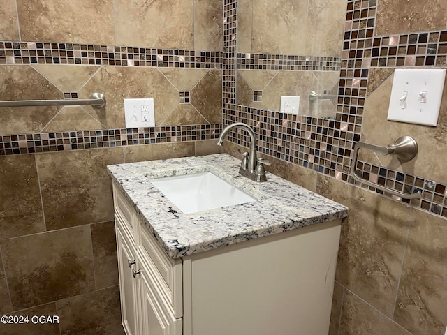 bathroom featuring tile walls, tasteful backsplash, and vanity