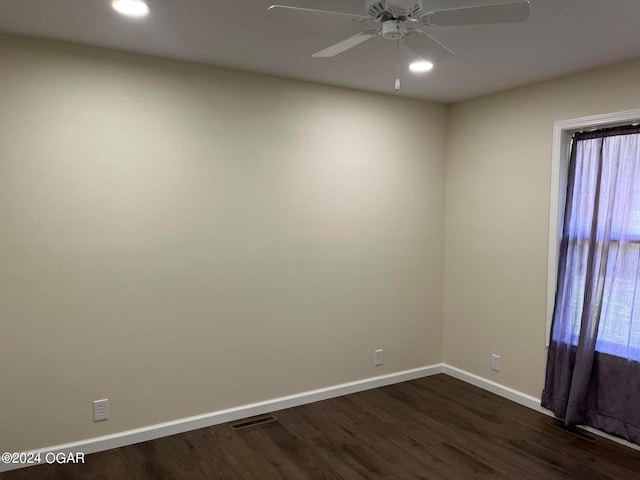 unfurnished room with ceiling fan and dark hardwood / wood-style flooring