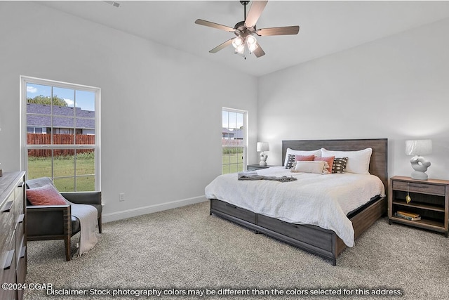 carpeted bedroom featuring ceiling fan and multiple windows