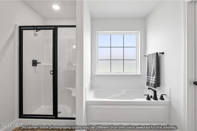 bathroom featuring independent shower and bath