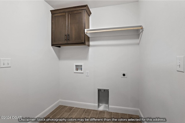 laundry area with hookup for an electric dryer, cabinets, wood-type flooring, and hookup for a washing machine