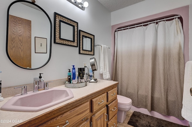 bathroom featuring a shower with shower curtain, tile patterned floors, toilet, vanity, and a textured ceiling