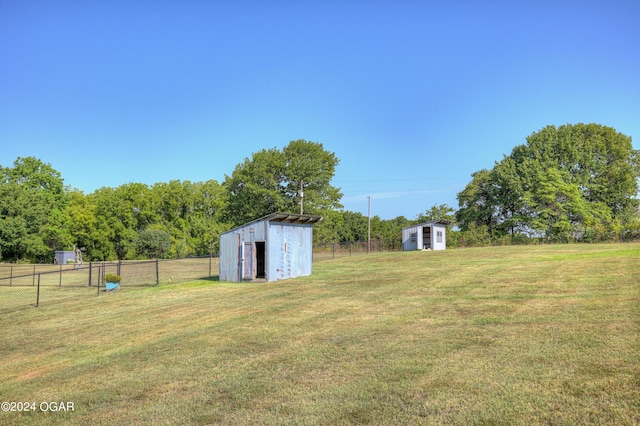 view of yard featuring a rural view and a storage shed