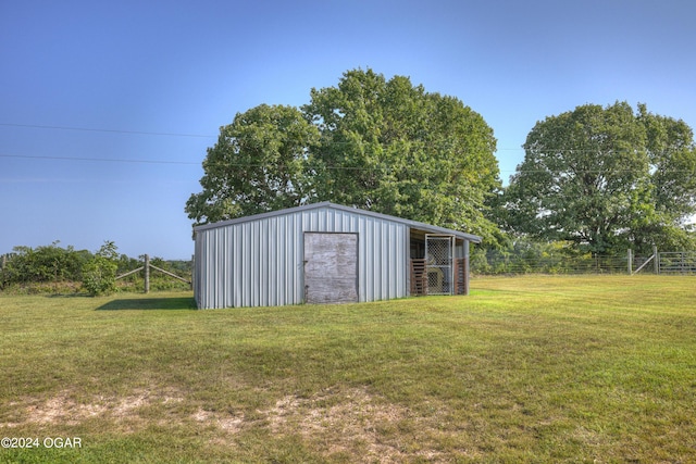 view of outdoor structure featuring a lawn