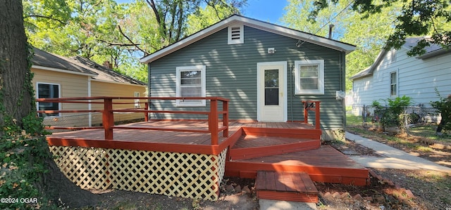 back of property featuring a wooden deck