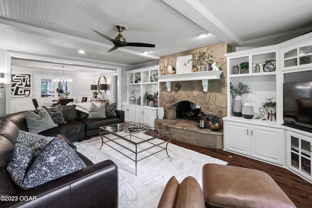 living area featuring dark wood-style floors, ornamental molding, a fireplace, and beam ceiling