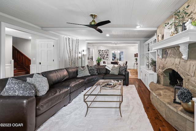 living room featuring ceiling fan, a fireplace, and dark wood-type flooring