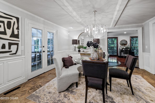 dining room featuring plenty of natural light, french doors, a chandelier, and ornamental molding