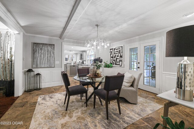 dining space featuring crown molding, an inviting chandelier, and french doors