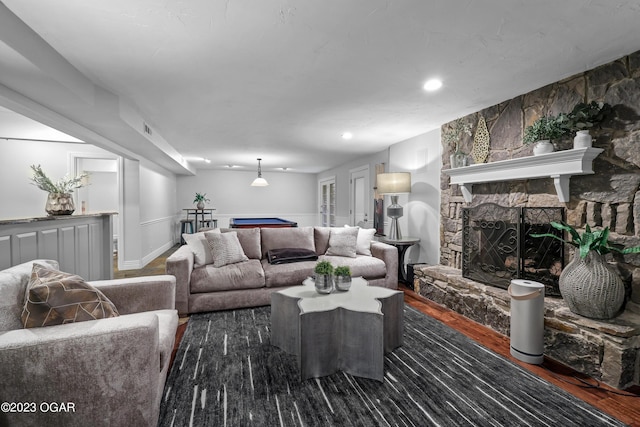 living room with billiards, visible vents, wood finished floors, a stone fireplace, and recessed lighting