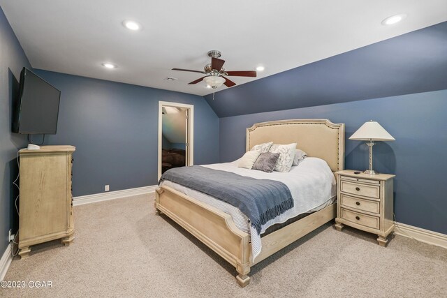 bedroom with light colored carpet, lofted ceiling, and ceiling fan