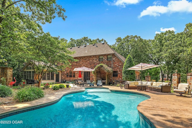 view of swimming pool with an outdoor living space and a patio area