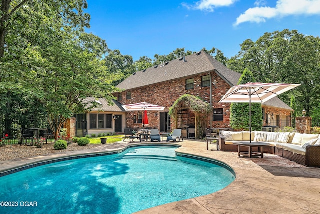 outdoor pool featuring fence, an outdoor living space, and a patio