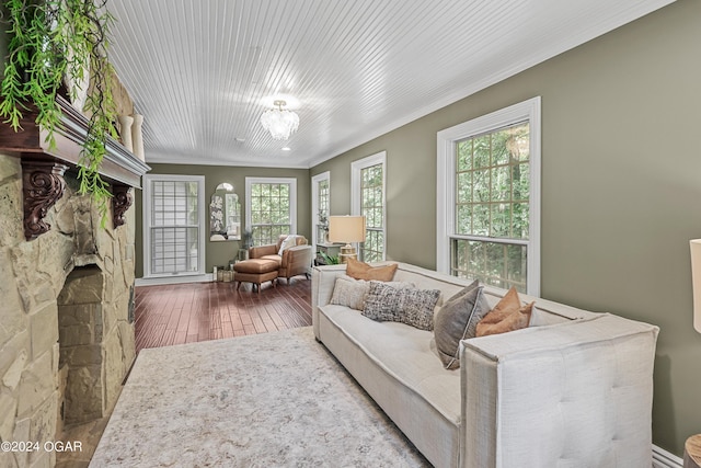 living room featuring ornamental molding, hardwood / wood-style flooring, and an inviting chandelier