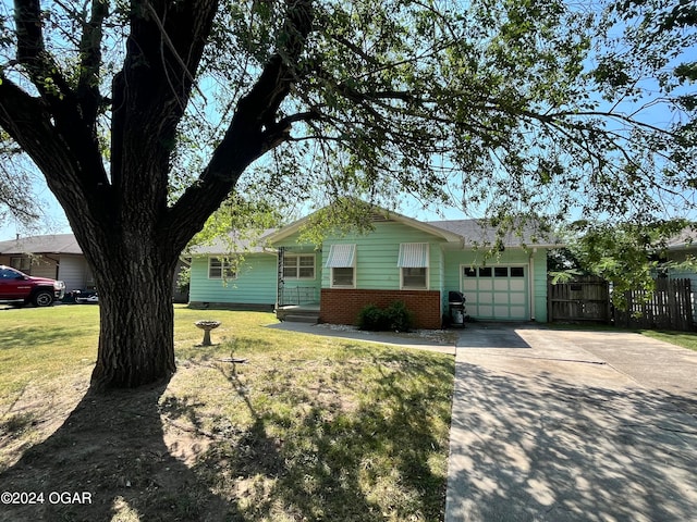 ranch-style house with a front lawn and a garage