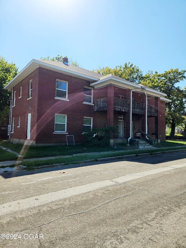 view of front of home with a balcony