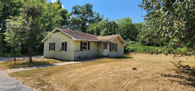 view of side of home featuring a lawn