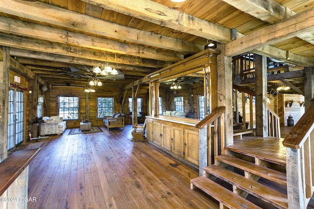 interior space with hardwood / wood-style floors, wooden ceiling, a notable chandelier, and beamed ceiling